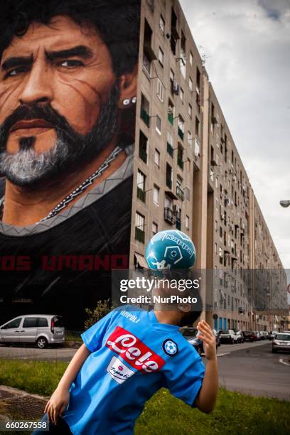 Children that dribble of Taverna Del Ferro, San Giovanni a Teduccio, peripheral of Naples EST on March 29, 2017 in front a Graffiti Revolucionario by...