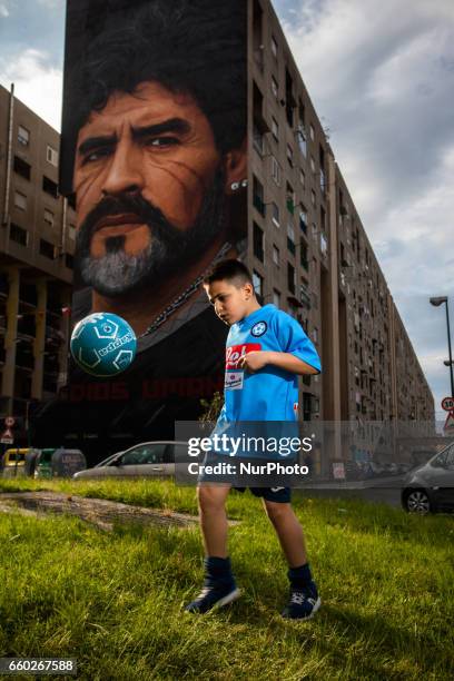 Children that dribble of Taverna Del Ferro, San Giovanni a Teduccio, peripheral of Naples EST on March 29, 2017 in front a Graffiti Revolucionario by...