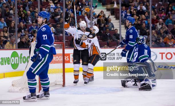 Anaheim Ducks Center Antoine Vermette and Right Wing Patrick Eaves celebrate Eaves' first period goal in behind Vancouver Canucks Goalie Ryan Miller...