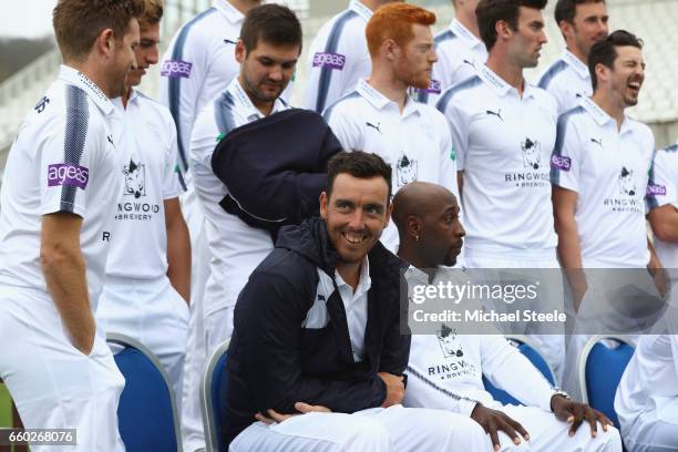 Kyle Abbott of Hampshire braves the cold as he sits alongside Michael Carberry and team mates during the Hampshire County Cricket photocall at...