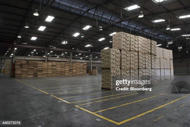 Pallets of Empresas Polar SA P.A.N. Brand cornmeal sit next to empty storage spots at the company's processing and distribution facility in Turmero,...