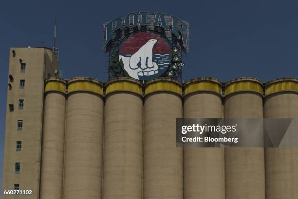 The Empresas Polar SA beer logo is displayed above a barley storage facility at the Cerveceria Polar CA plant in San Joaquin, Venezuela, on Thursday,...