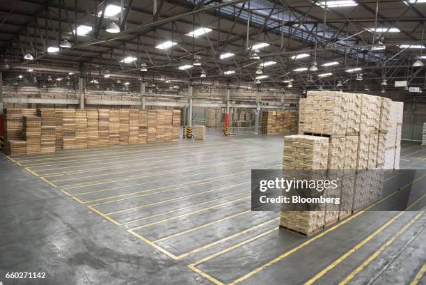 Pallets of Empresas Polar SA P.A.N. Brand cornmeal sit next to empty storage spots at the company's processing and distribution facility in Turmero,...