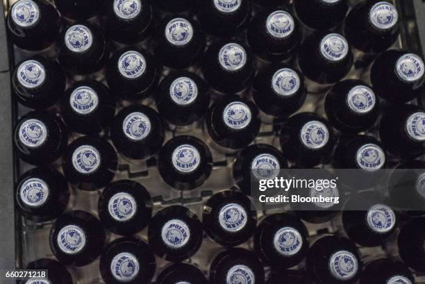 Empresas Polar SA beer bottles move through the production line at the Cerveceria Polar CA plant in San Joaquin, Venezuela, on Thursday, March 16,...