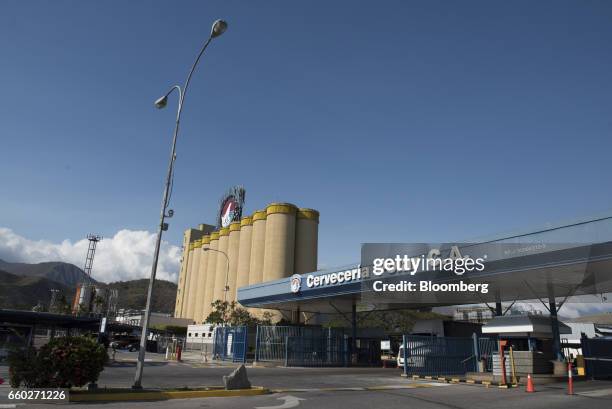 Signage is displayed at the entrance of Cerveceria Polar CA plant, a subsidiary of Empresas Polar SA, in San Joaquin, Venezuela, on Thursday, March...