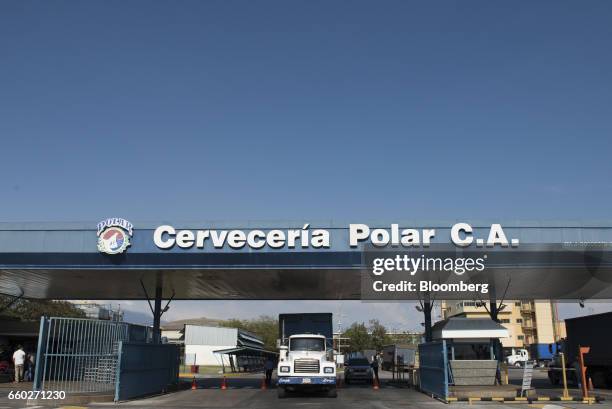 Signage is displayed at the entrance of Cerveceria Polar CA plant, a subsidiary of Empresas Polar SA, in San Joaquin, Venezuela, on Thursday, March...