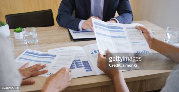 banker discussing with couple - flyer leaflet stock pictures, royalty-free photos & images