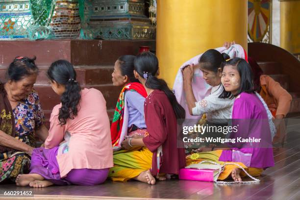 People worshipping at the 2,500 years old Shwedagon Pagoda in Yangon , the largest city in Myanmar.