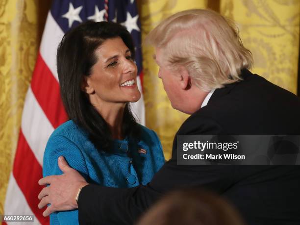 President Donald Trump greets U.N. Ambassador Nikki Haley during an event celebrating Women's History Month, in the East Room at the White House...