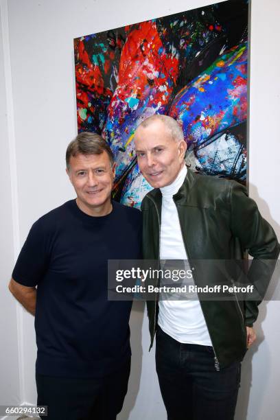 Jerome Revon and Jean-Claude Jitrois pose in front of a work of Jerome Revon, made on a blouson of Jean-Claude Jitrois, during the 'Art Paris Art...