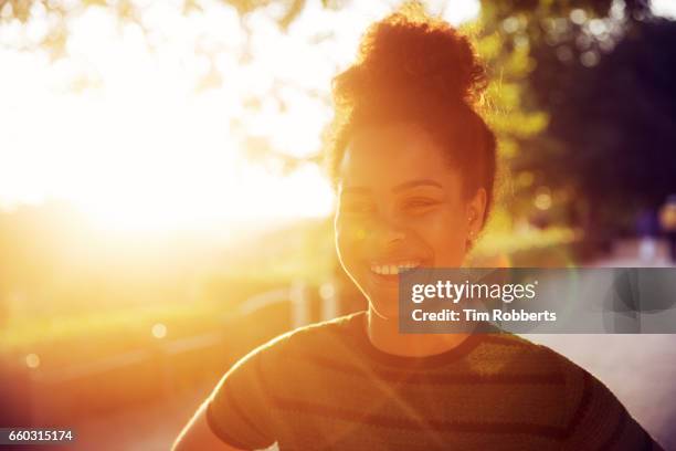 smiling woman at sunset - gold lens flare stock pictures, royalty-free photos & images