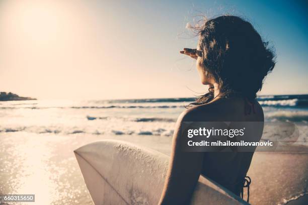 surf girl looking into distance - surfer by the beach australia stock pictures, royalty-free photos & images