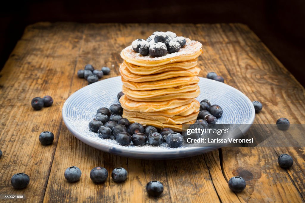 Stack of Pancakes with blueberries on blue plate