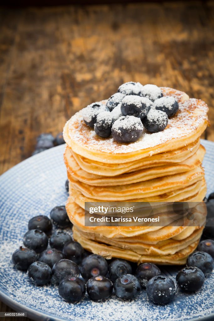 Stack of Pancakes with blueberries on blue plate