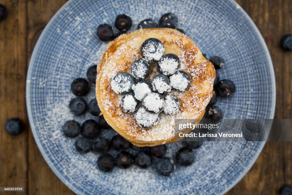 Stack of Pancakes with blueberries on blue plate