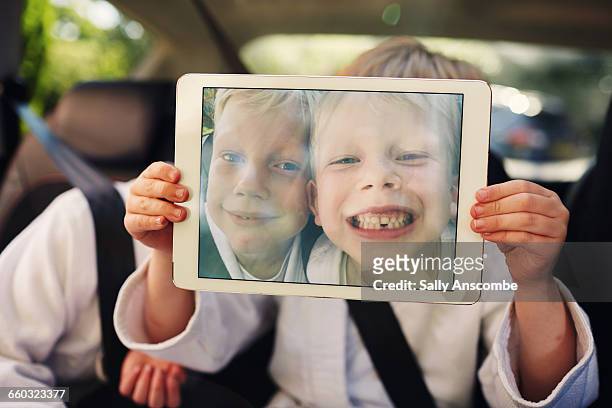 children using an electronic tablet - child car tablet stock pictures, royalty-free photos & images