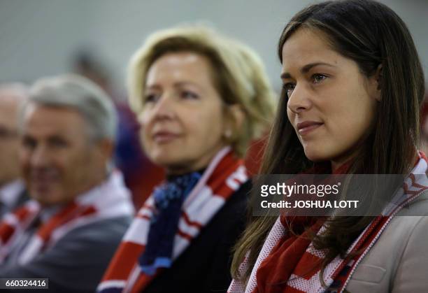 Ana Ivanovic listens to her husband and Chicago Fire's new midfielder Bastian Schweinsteiger speak after officially being introduced during a news...