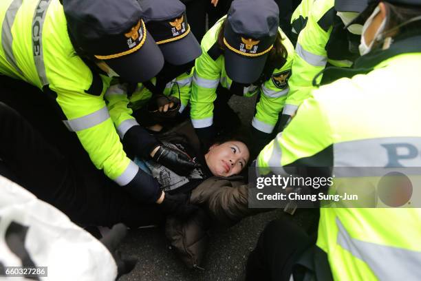 Police officers scuffle with protesters as they demand the arrest of ousted South Korean President Park Geun-hye, in front of her private home on...