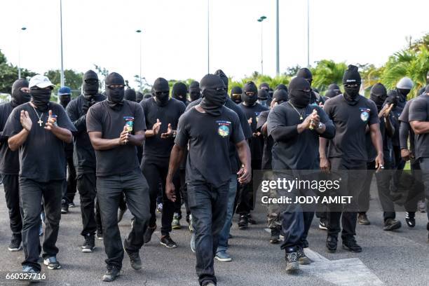 Members of The 500 Brothers group walk on a road during a protest in support of the general strike on March 29, 2017 in Cayenne, French Guiana. Life...