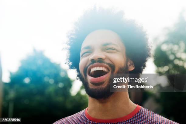 excited man looking up - curly hair man stock pictures, royalty-free photos & images