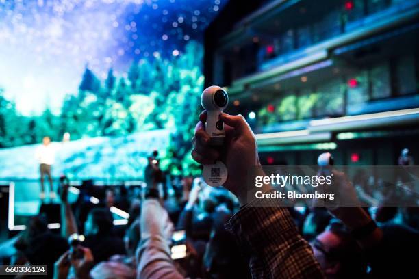 Attendees use Samsung Electronics Co. Gear 360 camera during the company's Unpacked product launch event in New York, U.S., on Wednesday, March 29,...