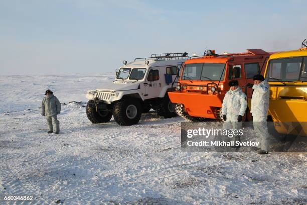 Russian military off-road trucks are seen the shore of Barents Sea near the polar camp at Alexandra Land Island, Franz Joseph Land Archipelago in...