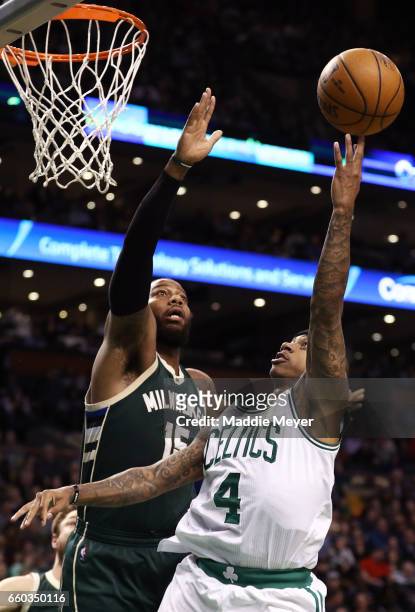 Isaiah Thomas of the Boston Celtics takes a shot against Greg Monroe of the Milwaukee Bucks during the third quarter at TD Garden on March 29, 2017...