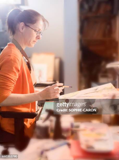 a woman and her work. - petite entreprise stock pictures, royalty-free photos & images