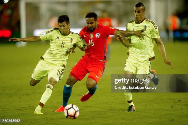Jean Beausejour of Chile fights for the ball with Renzo Zambrano of Venezuela during a match between Chile and Venezuela as part of FIFA 2018 World...