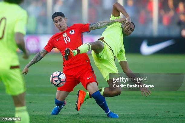 Pedro Pablo Hernandez of Chile fights for the ball with Salomon Rondon of Venezuela during a match between Chile and Venezuela as part of FIFA 2018...