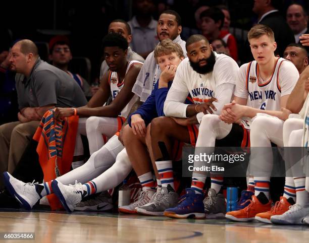 Carmelo Anthony,Mindaugas Kuzminskas,Kyle O'Quinn and Kristaps Porzingis of the New York Knicks look on from the bench in the fourth quarter against...