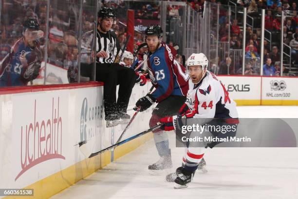 Mikhail Grigorenko of the Colorado Avalanche attempts to pass the puck past Brooks Orpik of the Washington Capitals at the Pepsi Center on March 29,...