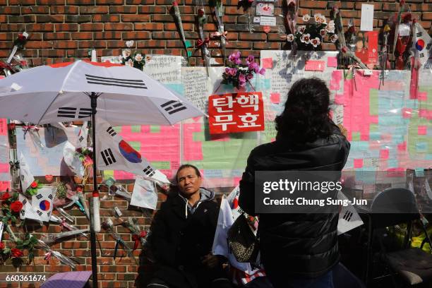 Supporter of ousted South Korean President Park Geun-hye sits in front of her private home on March 30, 2017 in Seoul, South Korea. A hearing to...