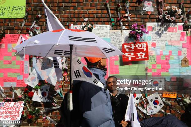 Supporter of ousted South Korean President Park Geun-hye sits in front of her private home on March 30, 2017 in Seoul, South Korea. A hearing to...