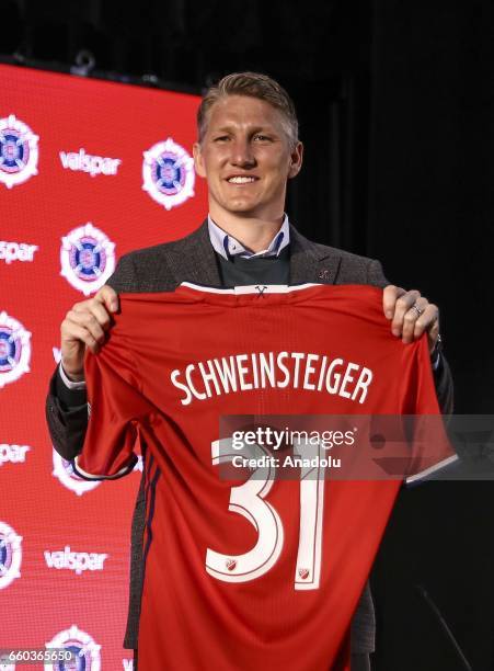 German football player Bastian Schweinsteiger poses with his jersey as he is introduced at The PrivateBank Fire Pitch in Chicago, Illinois, USA, 29...