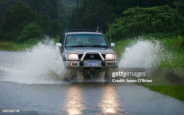 Car drives through water on March 30, 2017 in Billinudgel, Australia. Heavy rain and flash flooding is expected in south east Queensland and Northern...