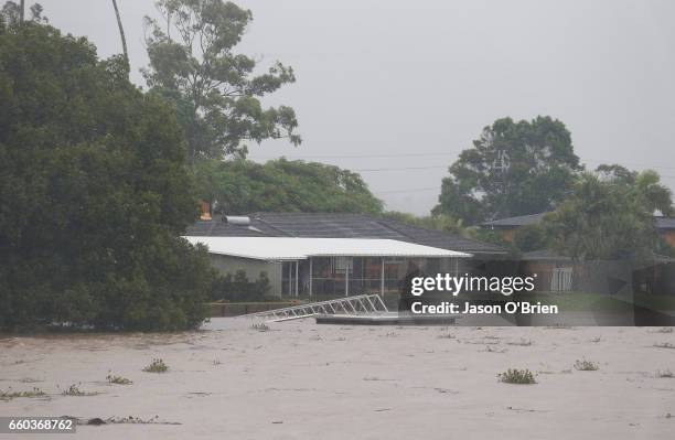 Houses along the tweed river as flood waters rise on March 30, 2017 in Murwillumbah, Australia. Heavy rain and flash flooding is expected in south...