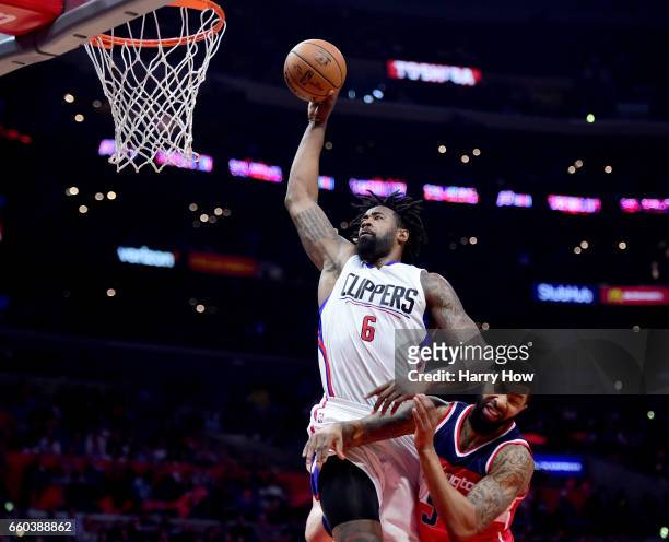 DeAndre Jordan of the LA Clippers dunks over Markieff Morris of the Washington Wizards during a 133-124 Clipper win at Staples Center on March 29,...