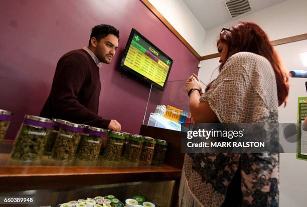 Customers buy marijuana products at the Perennial Holistic Wellness Center which is a medicinal marijuana dispensary in Los Angeles, California on...