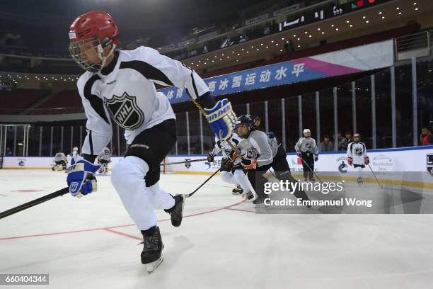 Young Chinese hockey players participate learn to play Youth Hockey Clinic during the NHL announcement in China at LeSports Center on March 30, 2017...