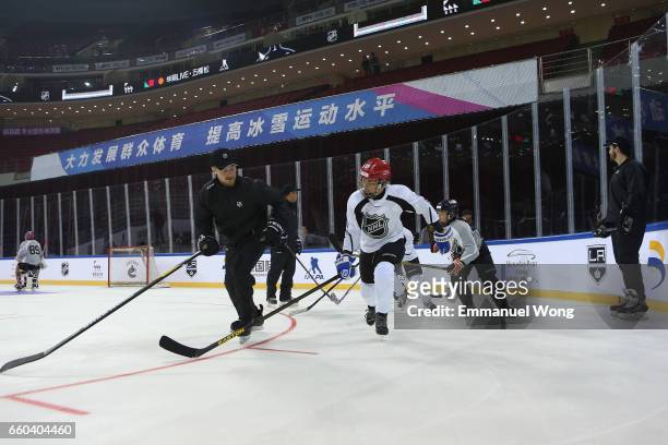 Young Chinese hockey players participate learn to play Youth Hockey Clinic during the NHL announcement in China at LeSports Center on March 30, 2017...
