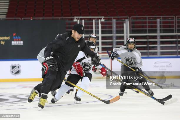 Young Chinese hockey players participate learn to play Youth Hockey Clinic during the NHL announcement in China at LeSports Center on March 30, 2017...