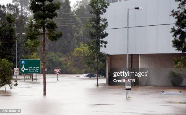 Flood waters enter in the parking lot outside the Robina Hospital on the Gold Coast as severe rain continue throughout south-east Queensland...