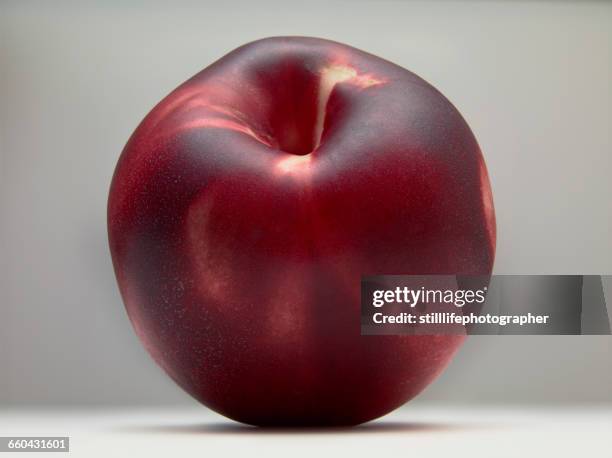 peach sitting on white surface - de color melocotón fotografías e imágenes de stock