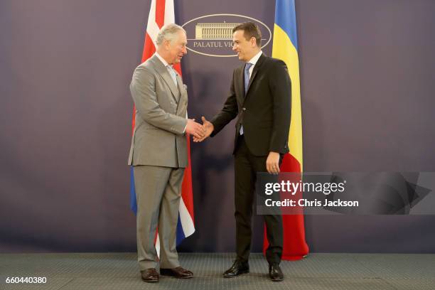 Prince Charles, Prince of Wales is greeted by Romanian Prime Minister Sorin Grindenau as he visits the Palatul Victoria, the office of the Prime...