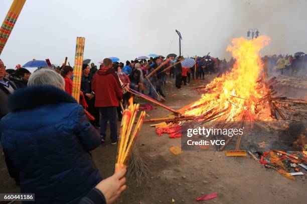 People crowd at Zhenwu Mountain to burn incense during the Sanyuesan Festival on March 30, 2017 in Xiangyang, Hubei Province of China. Thousands of...