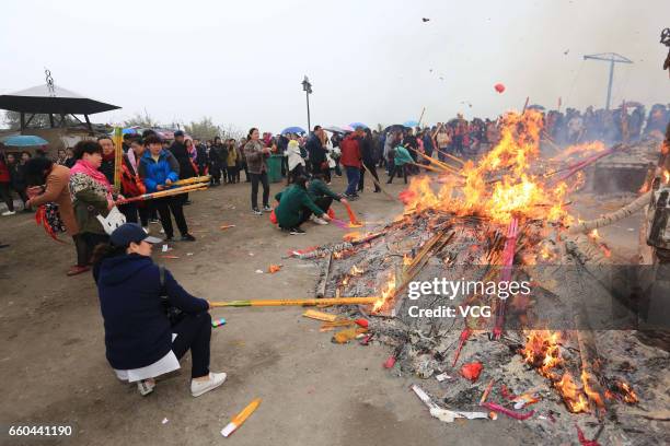 People crowd at Zhenwu Mountain to burn incense during the Sanyuesan Festival on March 30, 2017 in Xiangyang, Hubei Province of China. Thousands of...