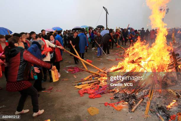 People crowd at Zhenwu Mountain to burn incense during the Sanyuesan Festival on March 30, 2017 in Xiangyang, Hubei Province of China. Thousands of...