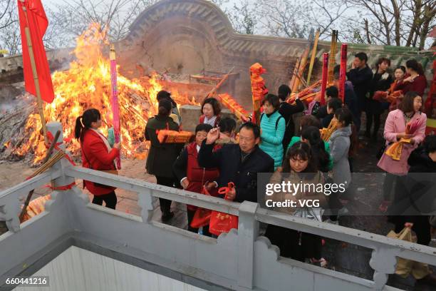 People crowd at Zhenwu Mountain to burn incense during the Sanyuesan Festival on March 30, 2017 in Xiangyang, Hubei Province of China. Thousands of...