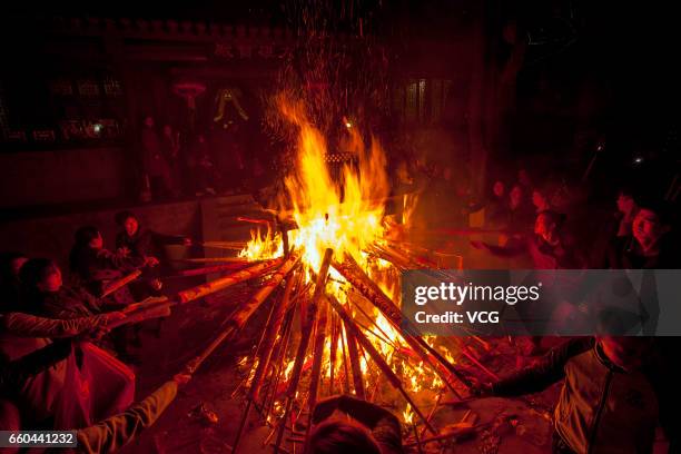 People crowd at Zhenwu Mountain to burn incense during the Sanyuesan Festival on March 30, 2017 in Xiangyang, Hubei Province of China. Thousands of...